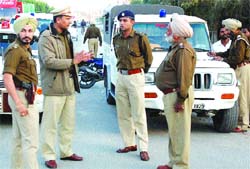 Accompanied by ASP Inderbir Singh (left), SSP R.K. Jaiswal inspects a naka put up for challaning violators in Jalandhar on Wednesday.