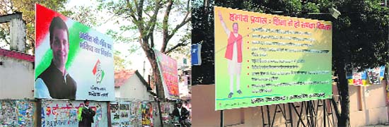 Hoardings put up by the Congress and BJP in Dehradun.