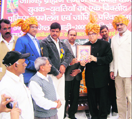 Capt Ajay Singh Yadav releases a directory of the Jangir Brahman Samaj in Rewari.