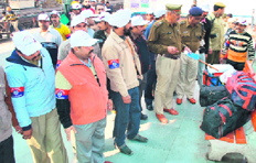GRP officials check the luggage of a passenger with the help of wardens at Ambala Cantt railway station.