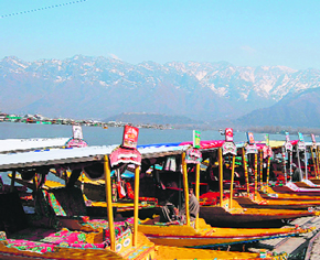 In the absence of tourists, these shikara owners sit idle in Srinagars Dal Lake on Thursday.