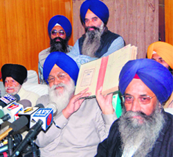SGPC president Avtar Singh shows the list of rare books and manuscripts in Amritsar on Friday. On left is CBI Inspector Ranjit Singh Nanda