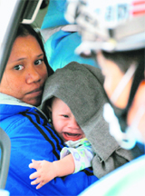 A baby cries in an ambulance at Narita Airport in Chiba Prefecture near Tokyo on Friday. About 30 persons were injured when a Northwest Airlines flight from Manila to Tokyo hit turbulence