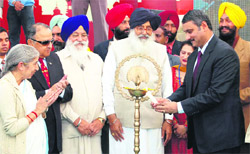 Union Minister of Health and Family Welfare Ambumani Ramadoss (right) lights the lamp to inaugurate a health awareness campaign at SGPC-run SGRD Medical College in Amritsar on Saturday.