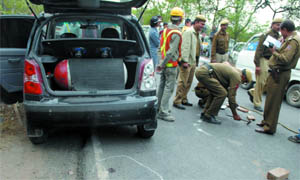 Forensic experts examine the site of the shootout.