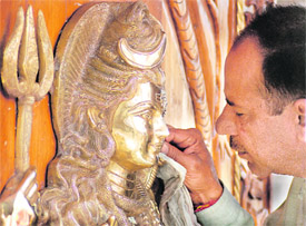 An artist gives final touches to an idol of Lord Shiva on the eve of Shivratri in Ludhiana on Sunday.