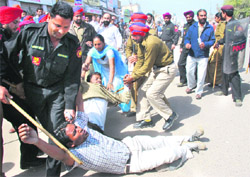 Protesters being taken into custody in Bathinda on Sunday.