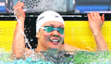 Japans Shiho Sakai celebrates after breaking the world record in the womens 100-metre backstroke at the Japan Open short course swimming championships in Tokyo on Sunday.
