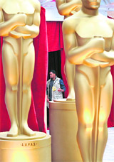 A security personnel stands behind Oscar statues on the red carpet front of the Kodak Theatre as the final preparations go on for the 81st Academy Awards in Hollywood, California, on Saturday.