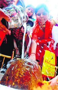 Devotees perform puja in a Jammu temple on the occasion of Shivratri on Monday.