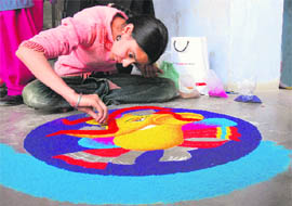 Girl participates in a rangoli contest during the cultural festival at GGNIMT in Ludhiana.