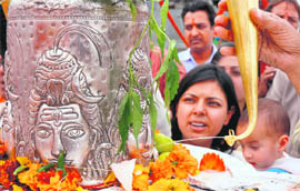 A devotee offers milk to Lord Shiva on the occasion of Shivratri in Ludhiana on Monday.