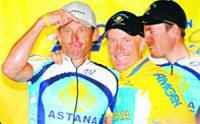 Lance Armstrong (L) gestures to teammate Levi Leipheimer of the USA and riding for Astana on the podium after Stage 8 as Leipheimer won the overall victory in the AMGEN Tour of California