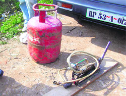 A domestic LPG cylinder and a gas filling device, which were recovered from a van during a surprise check by the IOC authorities in Nurpur.
