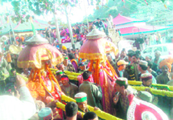 Palanquins of devtas being carried by devotees during the shobha yatra from Rajmadhav temple to Paddal Maidan 