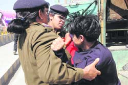 Women constables restrain an agitated B.Ed unemployed girl in front of the Assembly on Wednesday. 
