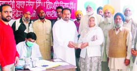 Patients being given medicine and dentures at the dental camp in Jalaldiwal village