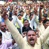Activists of the All India Health Employees and Workers Confederation shout slogans against health minister Ambumani Ramadoss for their various demands at Jantar Mantar in New Delhi on Thursday.