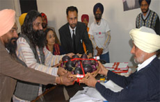 Khetri Virasat Mission activists presenting normal brinjal to ADC Upjit Singh Brar to protest against Bt brinjal variety in Bathinda on Friday.