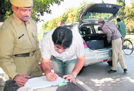 Policemen check vehicles at one of the entry points at Panjab University in Chandigarh on Friday.
