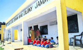 Students study in a verandah in Government High School, Resham Ghar Colony, Jammu.