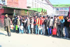 Youths stand in a queue during a police recruitment drive in Srinagar