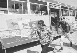 A policeman chases a PML-N worker protesting against the Supreme Courts decision to disqualify their leaders from polls in Multan on Saturday. 