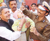 IG Shiel Madhur administers polio vaccine to a child at Wajirabad near Gurgaon on Sunday.