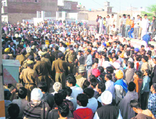 The police tries to pacify angry villagers on Sunday after they ransacked a police station following the murder of two women in Rori village in Sirsa.