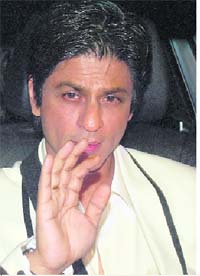 Shah Rukh Khan waves as he leaves the venue after attending the Filmfare Awards ceremony in Mumbai on Saturday. 