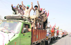 Activists of the PWD Talmel Sangharsh Committee move in a vehicle rally towards Lambi in Bathinda on Sunday.
