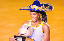 US Venus Williams holds her trophy and a Mexican mariachi hat, after beating Flavia Pennetta in the Acapulco WTA Open final on Saturday.