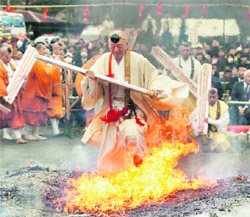 A Buddhist monk walks through flames as he holds a prayer board during the Nagatoro Fire Festival, a fire-walking ritual, at Choshozan Fudoji temple in Nagatoro town, north-west of Tokyo, on Sunday.