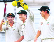 Phillip Hughes (L), Brad Haddin (C) and Marcus North celebrate after winning the first Test against South Africa.