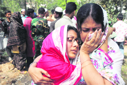 Relatives cry after seeing the coffins of BDR officers at a state funeral in 