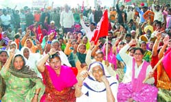 People protest against the police inaction at Majitha road police chowki bypass in Amritsar on Tuesday. 