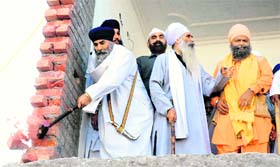 Members of Gurdwara Santsar Sahib demolish illegal structure on its premises in Chandigarh