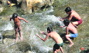 With temperatures, rising, children take a dip in the Tons river on the outskirts of Dehradun.