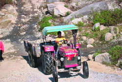 A tractor engaged in illegal mining in a river near Palampur