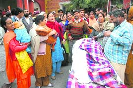 Relatives wail over the death of Rekha Kumari at SMGS Hospital in Jammu on Tuesday. 
