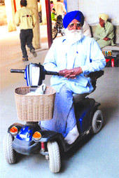 Kapoor Singh of Karar village on his four-wheel scooter.
