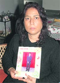 Ruma Bhattacharjiwith a picture of her son Anupam at her residence in Indira Nagar, Dehradun