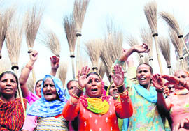 Municipal workers hold a protest demanding the implementation of the Sixth Pay Commission report in Karnal on Wednesday.
