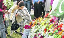 People lay flowers at the site of attack on the Sri Lankan cricket team in Lahore on Wednesday