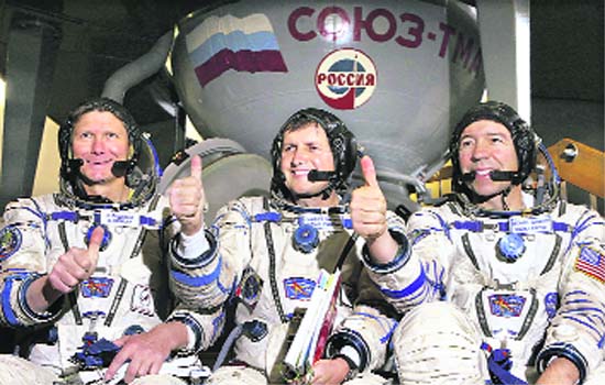(From left): Russian cosmonaut and crew commander Gennay Padalka, US space tourist Charles Simonyi and American NASA astronaut Michael Barratt right before the start of their training session in mock-up of a Soyuz TMA space craft at the Star City outside Moscow on Wednesday. The crew is to blast off for the International Space Station from Baikonur cosmodrome on March 26 on Russian-made Soyuz spaceship. 