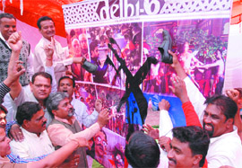 BJP activists blacken a poster of film 'Delhi 6' during a protest in New Delhi on Thursday. They alleged that derogatory remarks were made against a particular caste in the film. Tribune photo: Manas Ranjan Bhui