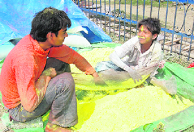 Boys in a playful mood as they prepare colours for Holi in Dehradun.