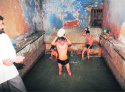 Children have a bath in a hot water source in Sohna.