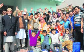 Stranded Kargil-bound people stage a demonstration in front of Kargil House in Jammu