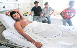 Tharanga Paranavitana lies on his bed at a private hospital in Colombo on Thursday.